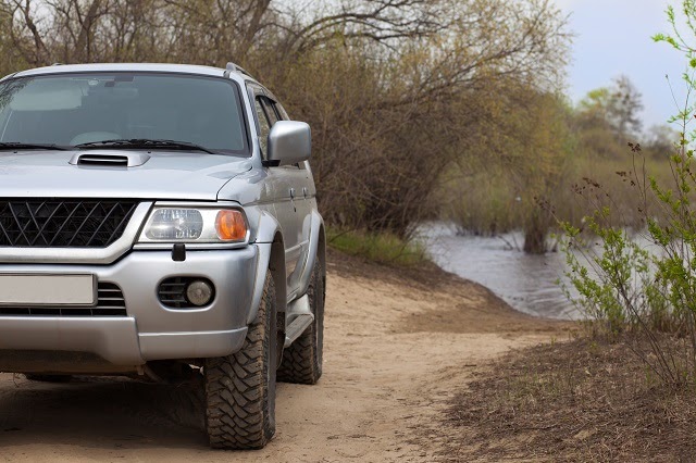 4x4 SUV on a road near a river