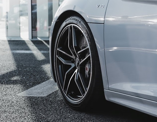 A close-up of a white car parked outside