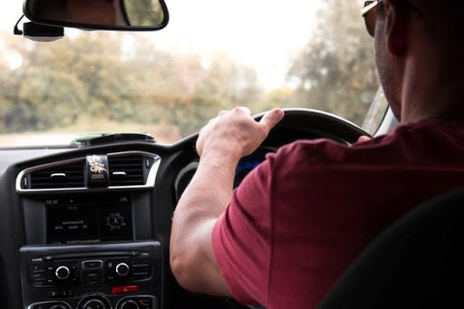 Person driving a car during daytime